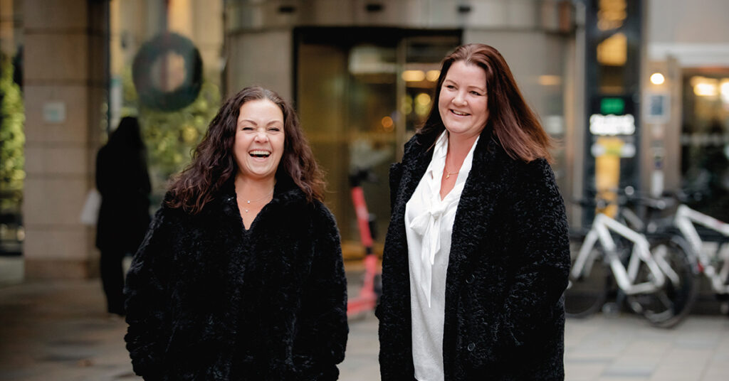 Two women of Avanta standing outside