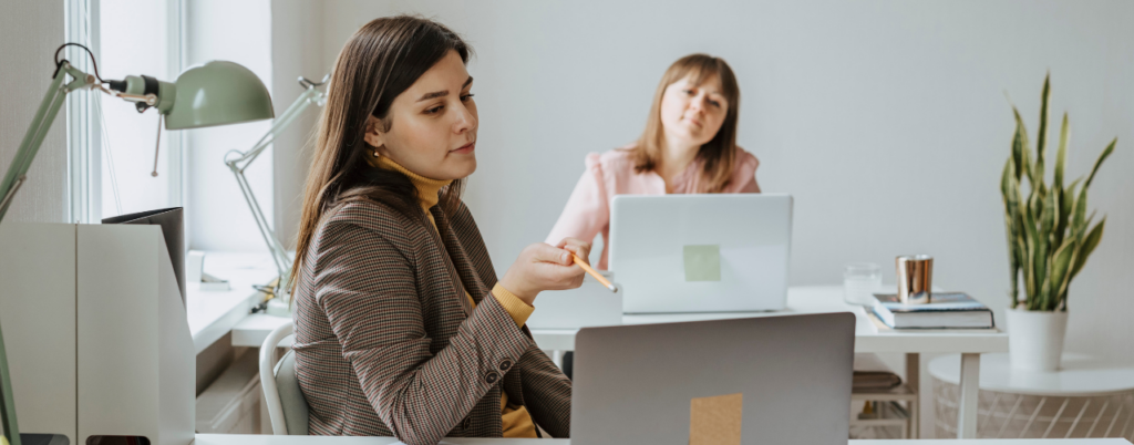 Twee vrouwen bespreken btw-aangifte op kantoor – alles wat je moet weten over btw-aangifte met Bjorn Lunden
